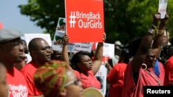 Protesters march in support of the girls kidnapped by members of Boko Haram in front of the Nigerian Embassy in Washington on May 6, 2014. 