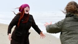 People scream at the sea to express their frustration as the Netherlands undergoes another lockdown, in The Hague, Netherlands January 5, 2022. Picture taken January 5, 2022. (REUTERS/Piroschka van de Wouw)