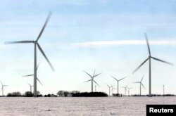 Wind turbines, whose blinking red lights often guide migrants walking from the United States to enter Canada, are seen in a field near Emerson, Canada, Feb. 25, 2017.