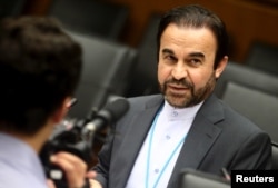FILE - Iran's ambassador to the International Atomic Energy Agency (IAEA) Reza Najafi waits for the start of a board of governors meeting at the IAEA headquarters in Vienna, Austria, June 10, 2015.