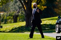 President Joe Biden walks on the South Lawn of the White House before boarding Marine One, in Washington, Nov. 10, 2021.