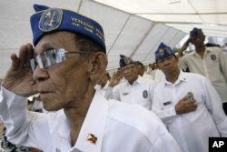 FILE - Filipino veterans salute during ceremonies for U.S. Memorial Day at the American Cemetery in suburban Taguig, south of Manila, Philippines, May 24, 2009.