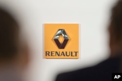 FILE - The logo of French car maker Renault is seen at a news conference in Paris, Feb. 12, 2015.