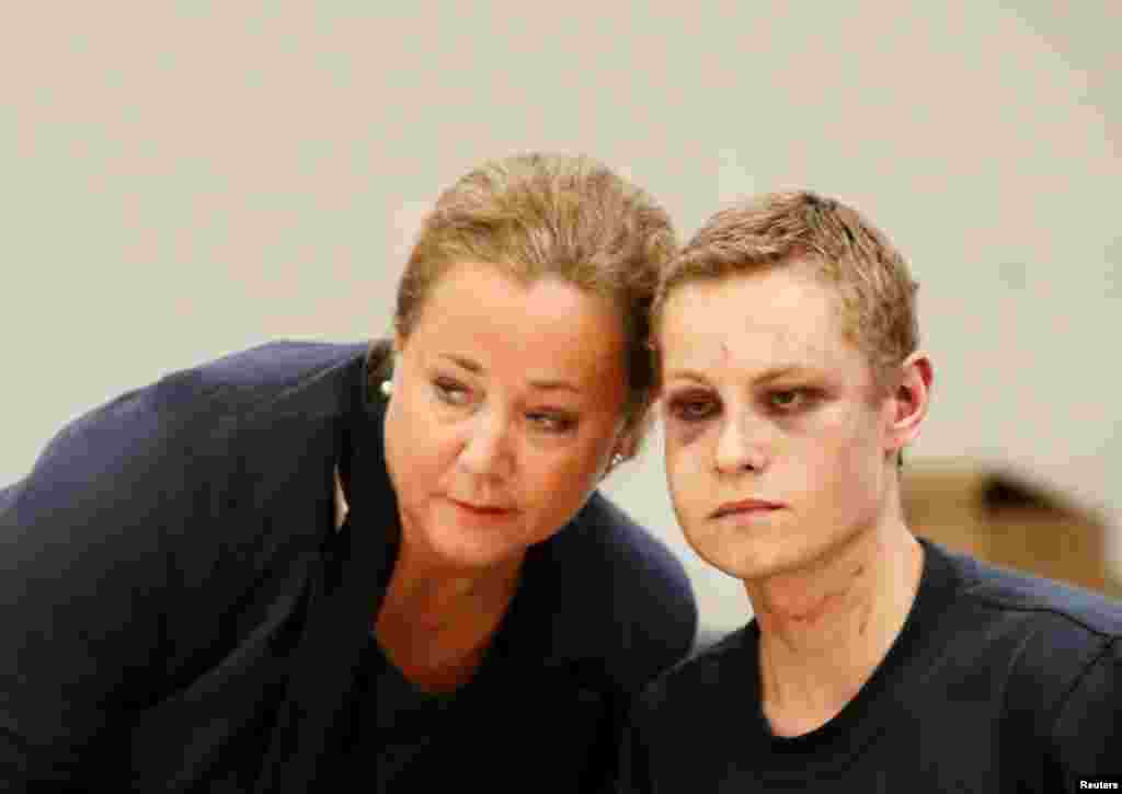 Philip Manshaus, with black eyes and wounds on his face and neck, appears with his lawyer Unni Fries in court in Oslo, Norway. Manshaus, 21, is suspected of an armed attack at Al-Noor Islamic Centre Mosque and killing his stepsister.
