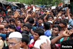 FILE - Rohingya refugees shout slogans as they take part in a protest at the Kutupalong refugee camp to mark the one-year anniversary of their exodus, in Cox's Bazar, Bangladesh, Aug. 25, 2018.