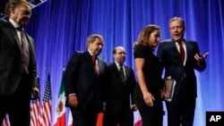 Canadian Chief Negotiator Steve Verheul, left, walks next to Canadian Ambassador to the U.S. David McNaughton, and U.S. Chief Negotiator John Melle, as Canadian Foreign Affairs Minister Chrystia Freeland, talks with U.S. Trade Representative Robert Lighthizer, right, after a news conference, Aug. 16, 2017, at the start of NAFTA renegotiations in Washington.