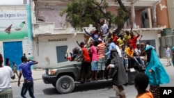 Protesters gather near the scene of Saturday's massive truck bomb attack in Mogadishu, Somalia, Oct. 18, 2017. Thousands of people took to the streets of Somalia's capital in a show of defiance after the country's deadliest attack.