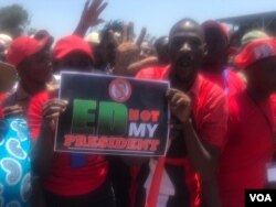 Members of the MDC led by Nelson Chamisa carrying a placard inscribed 'ED Not My President'