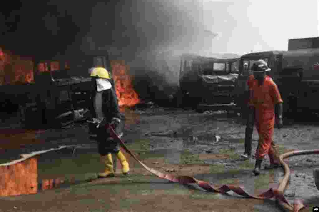Firefighters try to contain a fire at an informal diesel fuel depot in Lagos, Nigeria on Thursday, Feb. 16, 2012.