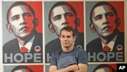 Street artist Shepard Fairey poses in front of the Barack Obama Hope artwork he designed.