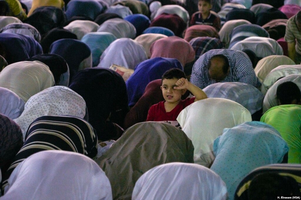 A young Muslim takes a break from the prayers, which lasted a few hours in Amr Ibn al-As mosque, in old Cairo, Egypt, May 31, 2019.