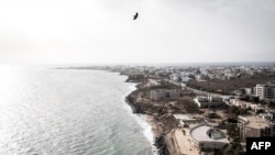 FILE — A photo of Mammelles beach, in front of construction sites in Dakar, on June 27, 2020. For years, developers have targeted Dakar's picture-postcard shoreline for developing luxury hotels and apartment blocks.. 