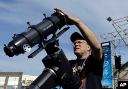 Ray Cooper, volunteer for the Oregon Museum of Science and Industry, preps his equipment to provide live video of the Aug. 21, 2017, solar eclipse at the state fairgrounds in Salem, Ore., Sunday, Aug. 20, 2017.