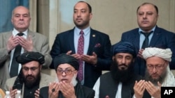 Taliban political chief Sher Muhammad Abbas Stanikzai, in the first row, second from left, and other Taliban officials pray during the intra-Afghan talks in Moscow, Feb. 6, 2019. 