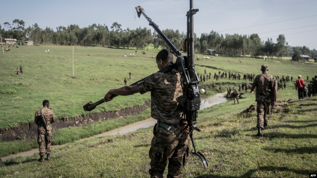 FILE - An Ethiopian National Defense Forces (ENDF) soldier carries a DShK 1938, a Soviet heavy machine gun, on his back during training in the field of Dabat, 70 kilometers northeast of the city of Gondar, Ethiopia, on Sept. 15, 2021.