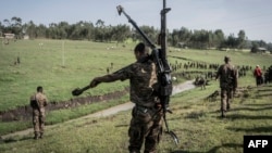 FILE - An Ethiopian National Defense Forces (ENDF) soldier carries a DShK 1938, a Soviet heavy machine gun, on his back during training in the field of Dabat, 70 kilometers northeast of the city of Gondar, Ethiopia, on Sept. 15, 2021.