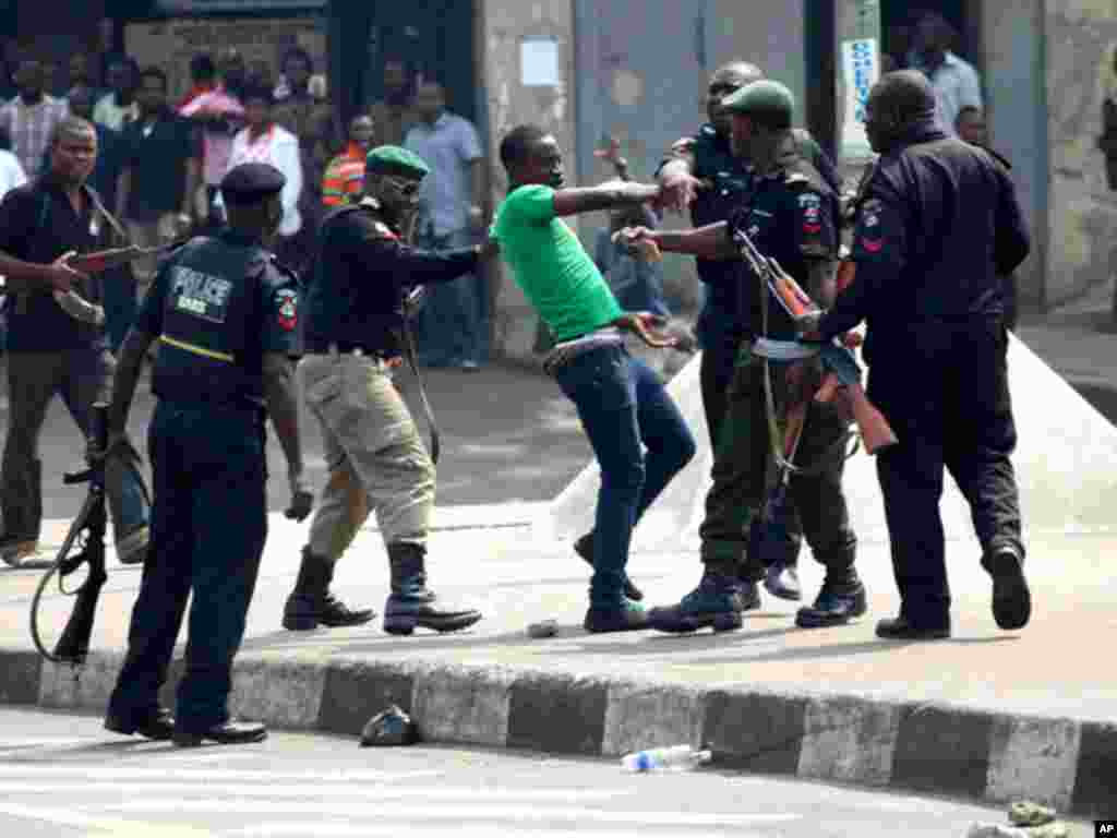 Nigerian police surround a protester during a demonstration in Lagos. (Reuters)