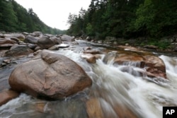 FILE - The Wassataquoik Stream flows through Township 3, Range 8, Maine, on land owned by environmentalist Roxanne Quimby, the co-founder of Burt's Bees. President Barack Obama in 2016 created the Katahdin Woods and Waters National Monument on 87,000 acres donated by Quimby.