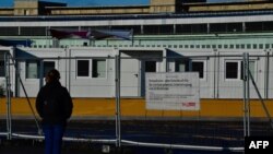 FILE - Temporary housing units for refugees are seen at the former Tempelhof airport in Berlin, Germany, Dec. 04, 2017.