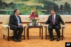 US Secretary of State Mike Pompeo, left, speaks with China's President Xi Jinping during a meetingat the Great Hall of the People in Beijing, Thursday, June 14, 2018. (Fred Dufour/Pool Photo via AP)