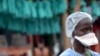 FILE - A health worker stands outside the Elwa hospital in Monrovia, Liberia, Sept. 7, 2014, 