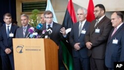 U.N. representative for Libya, Bernardino Leon, center, addresses reporters while Libyan parliaments members listen in Rabat, Morocco, Sept. 18, 2015..