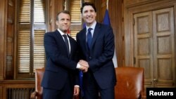 Canada's Prime Minister Justin Trudeau shakes hands with French President Emmanuel Macron during a meeting in Trudeau's office on Parliament Hill in Ottawa, Ontario, Canada, June 6, 2018.