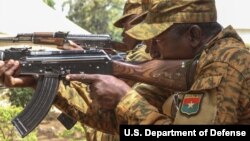 FILE - Burkinabe Soldiers perform a tactical reload drill near Po, Burkina Faso, Feb. 17, 2019. 