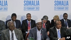 The President of Somalia, Sheikh Sharif Ahmed (C) speaks, as the President of Kenya, Mwai Kibaki (L) and Prime Minister of Somalia TFG, Abdiweli Mohamed Ali, listen during the London Conference on Somalia, in London, February 23, 2012.