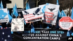 FILE - Uyghurs and their supporters rally near United Nations headquarters in New York, March 15, 2018.