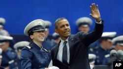 President Obama waves as he congratulates a cadet during the graduation ceremony at the United States Air Force Academy in Air Force Academy, Colo., Wednesday, May 23, 2012. (AP Photo/David Zalubowski)