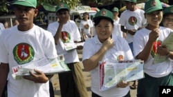 Members of the Union Solidarity and Development Party walk to distribute the party's leaflets for the upcoming general elections in Yangon, Burma. The general elections take place Nov. 7, the first in 20 years.