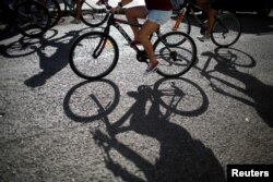 Bicyclists take part in a ride organized by BLH Masa Critica Habana to promote cycling as a clean and sustainable mode of transport, in Havana, Cuba, Aug. 5, 2018.