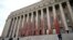 A view of the Parliament House of Finland after it was partially covered with red paint, during a protest to object peat collection by Neova company and to demand political action, in Helsinki, Sept. 25, 2024. (Lehtikuva/Emmi Korhonen via Reuters) 