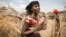 In this photo taken Jan. 26, 2016, Mayrem Humeyisu talks about food supply in her neighborhood in a rural village Dubti Woreda, Afar, Ethiopia. 