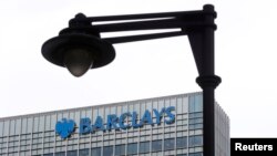 FILE - A security camera is seen near a Barclay bank office at Canary Wharf in London, Britain, May 19, 2015. 