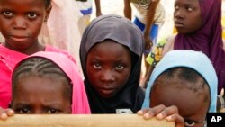 FILE - Displaced children attend class in Dori town, Burkina Faso, Aug. 7, 2021. The Norwegian Refugee Council said Burkina Faso’s slow and insufficient humanitarian response to the country’s escalating attacks was forcing schools to close. 