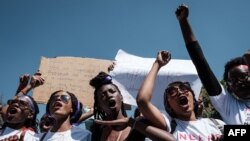 Kenyan women shout slogans as they participate in a feminist march against gender-based violence in Nairobi, March 8, 2019.