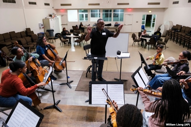 A string orchestra, part of an initiative to promote equity in classical music, rehearses at New Hope Presbyterian Church on Wednesday, Oct. 16, 2024, in Anaheim, California. (AP Photo/William Liang)