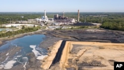 The Richmond city skyline is seen on the horizon behind the coal ash ponds near Dominion Energy's Chesterfield Power Station in Chester, Virginia, May 1, 2018. Scientists reported on June 7, 2018, the amount of heat-trapping carbon dioxide in the air peaked again this year at record levels. 