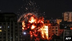 An explosion is pictured among buildings during an Israeli airstike on Gaza City on May 4, 2019. 