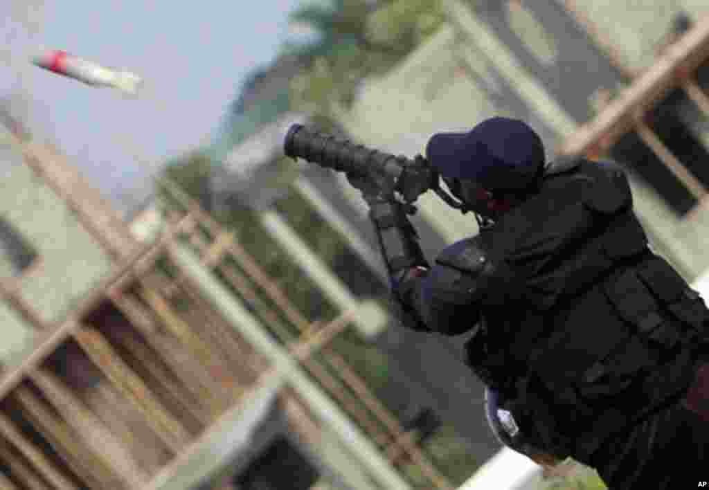 Equatorial Guinea's special police forces fire tear gas at Equatorial Guinea fans as they try to get inside Estadio de Bata "Bata Stadium", which will host the opening match and ceremony for the African Nations Cup, in Bata January 21, 2012.