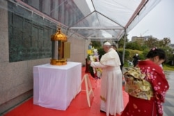 Pope Francis places a wreath during his visit to the Martyrs' Monument at Nishizaka Hill, in Nagasaki, Japan, Nov. 24, 2019.