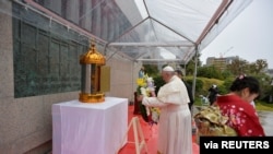 FILE - Pope Francis places a wreath during his visit to the Martyrs' Monument at Nishizaka Hill, in Nagasaki, Japan, November 24, 2019. (Vatican Media/­Handout via Reuters)