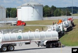 FILE - This Sept. 16, 2016, file photo shows tanker trucks lined up at a Colonial Pipeline Co. facility in Pelham, Ala., near the scene of a 250,000-gallon gasoline spill caused by a ruptured pipeline.