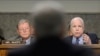 Senаtor John McCain (R) asks a question of defense secretary nominee Chuck Hagel (C) on Capitol Hill in Washington January 31, 2013, as Senator James Inhofe (L) looks on.