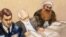 A sketch by a courtroom artist shows self-proclaimed terrorist mastermind Khalid Sheikh Mohammed, right, as he reviews court documents with his lawyers during the pre-trial hearing at the Guantanamo Bay U.S. Naval Base in Cuba, Feb. 12, 2013.