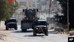 Israeli security forces raid the West Bank village of Deir Abu Mash'al near Ramallah, June 17, 2017, after an attack in Jerusalem killed a police officer.