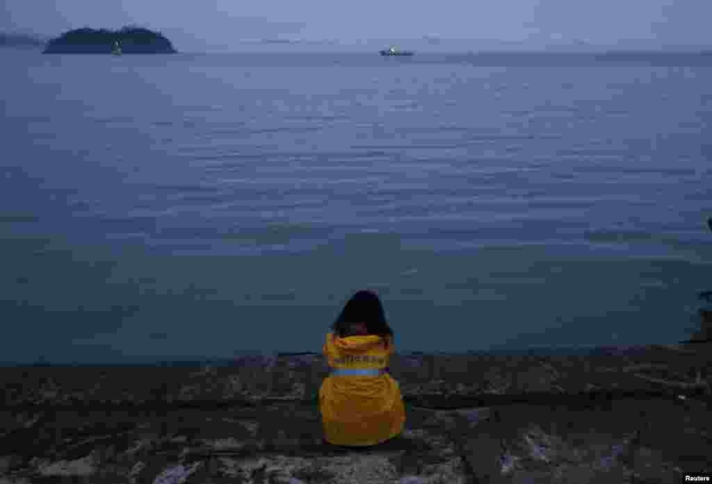 A family member of missing passengers who were on the Sewol ferry looks toward the site of the incident, Jindo, April 18, 2014.