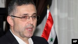 FILE - Ali Haidar, the Syrian Minister for Reconciliation Affairs, is interviewed in Damascus, Syria. 